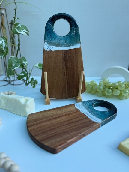 Mini handmade cheese board crafted from wildfire-rescued wood with unique ocean resin wave design, eco-friendly plant-based resin, customizable with engraving, gift-wrapped for holidays.
